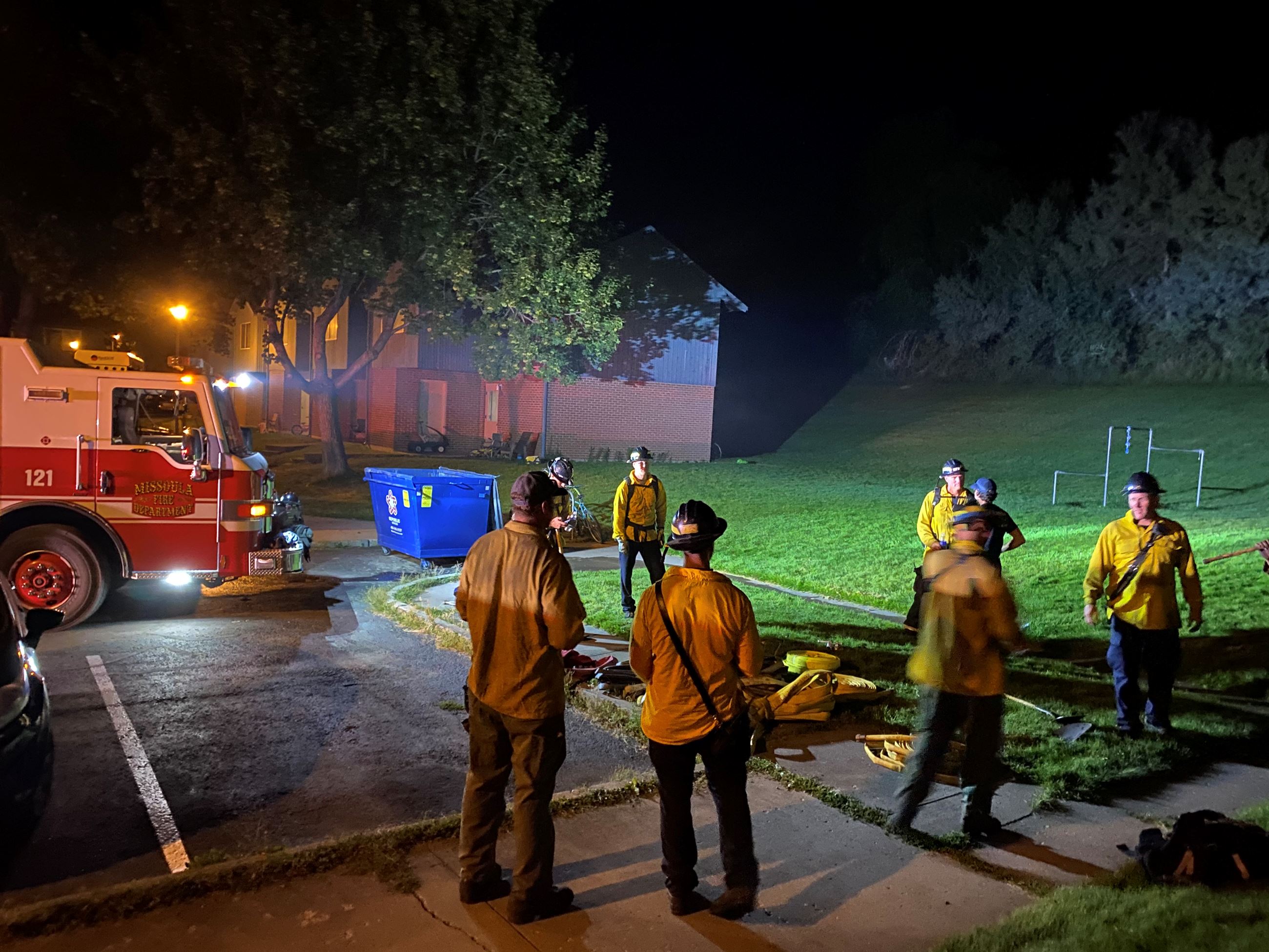 Crews gather at the base of Mt Sentinel at night, 2020